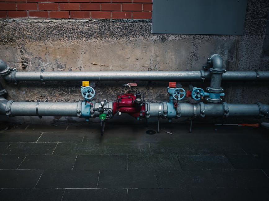 Plumber installing pipe insulation in Salem basement